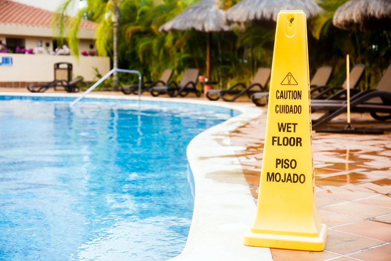 Caution sign by pool